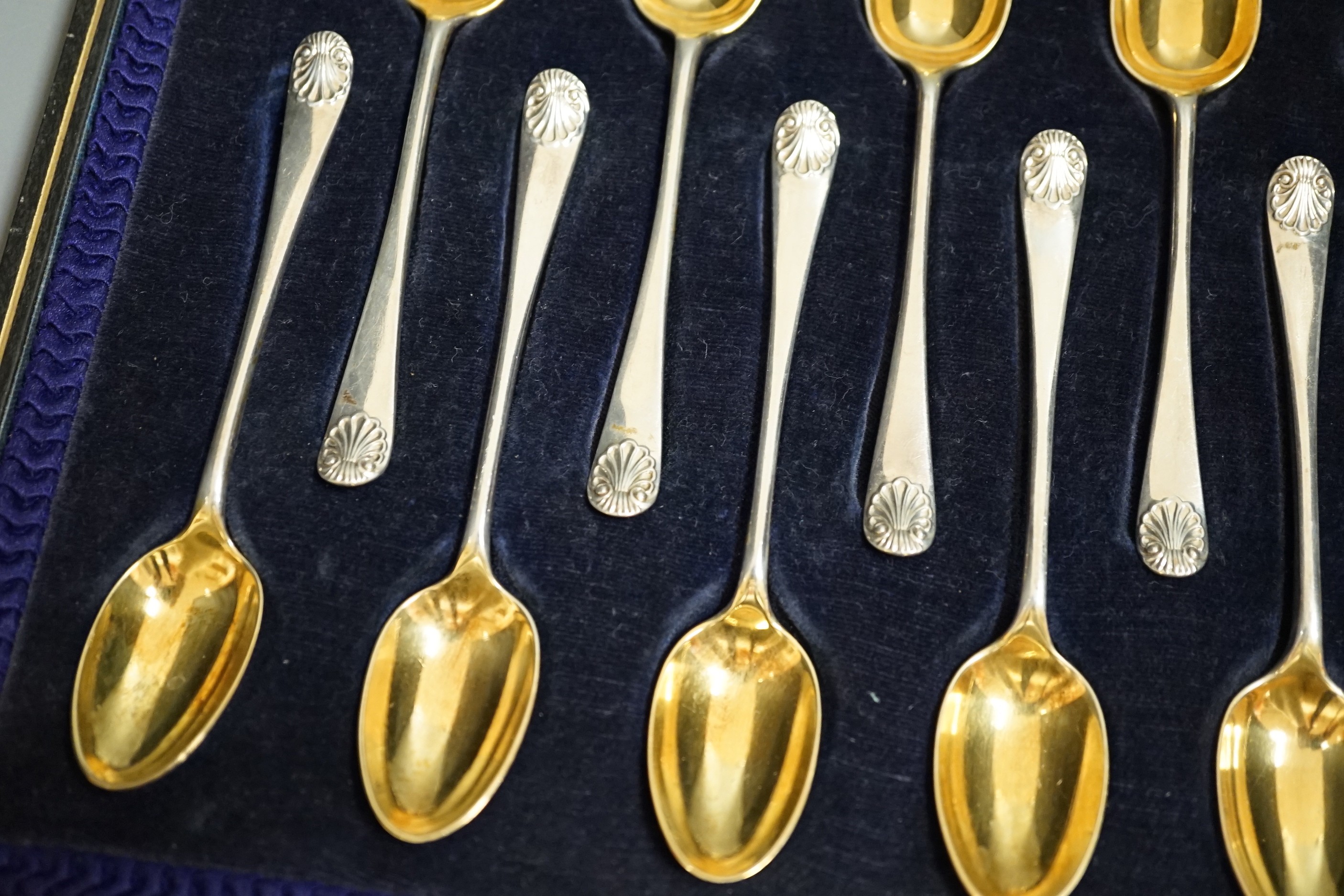 A cased set of twelve late Victorian silver 'picture back' coffee spoons, by Thomas Bradbury & Sons, London, 1896, 11.1cm.